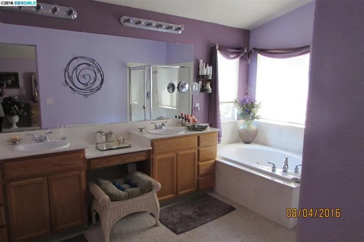 Master bath has tub, stall shower, double sinks and vanity area.
