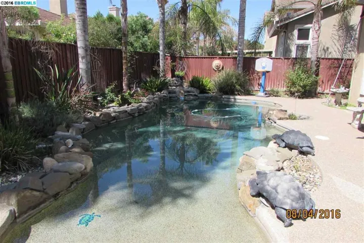 Built-in Pebble-Tech pool has a graduated shallow end to deep end. Beautiful trees and vegetation.