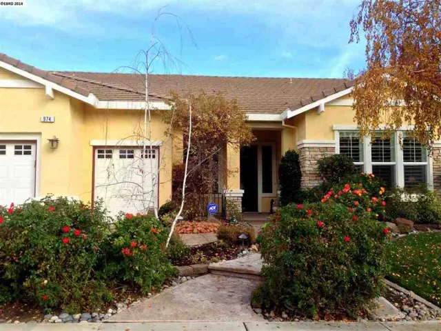 Professionally landscaped front yard and custom walkways boost the curb appeal of this elegant home.