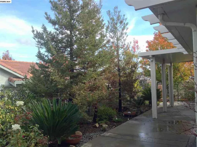 Large covered patio extends the living area outdoors. Park-like landscaping makes it complete.