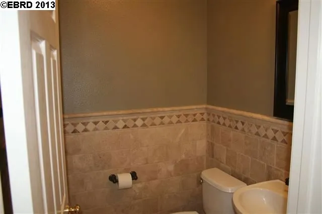 1/2 bath down stairs. Upgraded with lovely tile, pedestal sink and tile flooring.