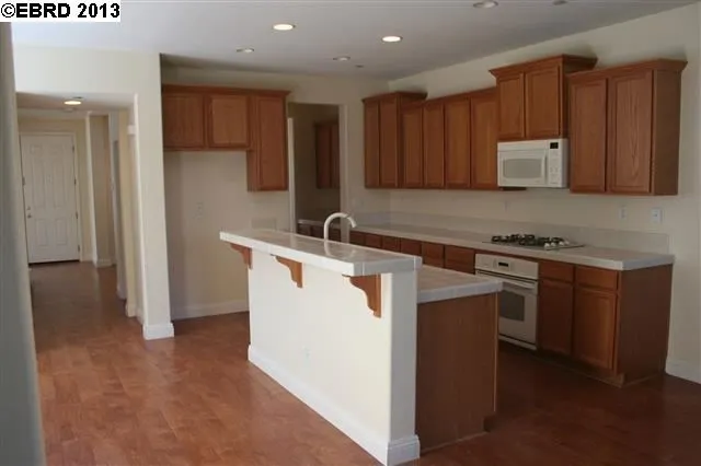 Kitchen has nice size breakfast bar and lots of cabinets.