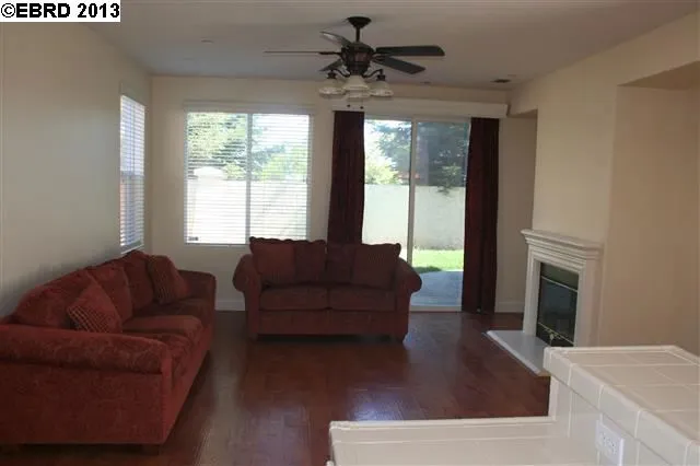 Has laminate flooring, slider to rear yard and door to garage.