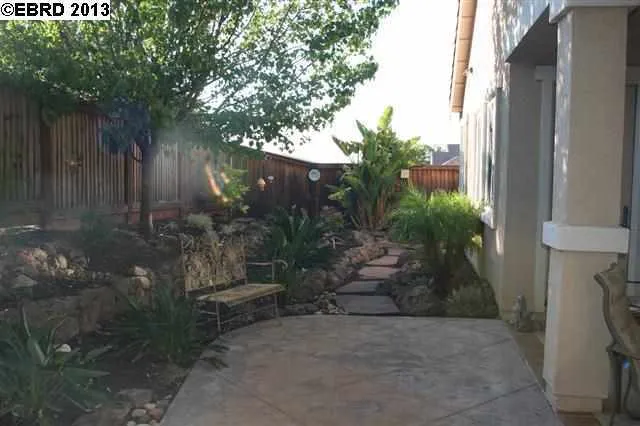 Beautifully landscaped, has stamped concrete on side of house. No rear neighbors!