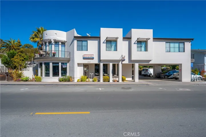 Street view of subject property with commercial space downstairs, and two residential units upstairs.