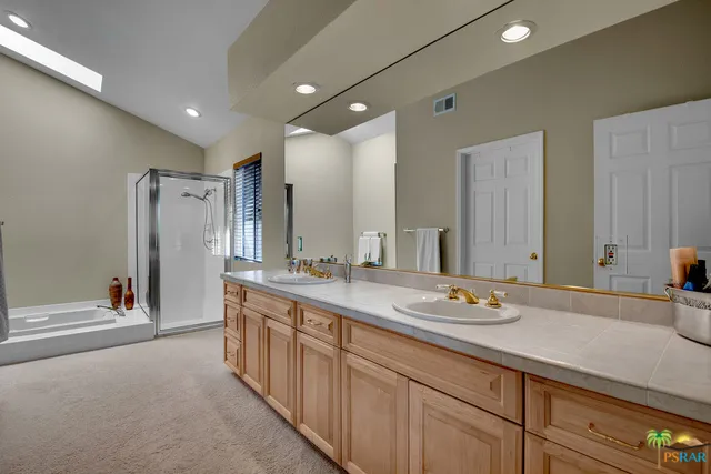 Skylighted master bathroom with walk in