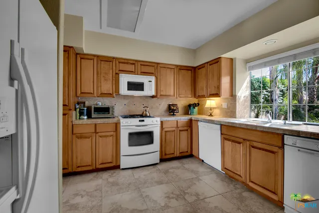 Sunny kitchen with views to courtyard.