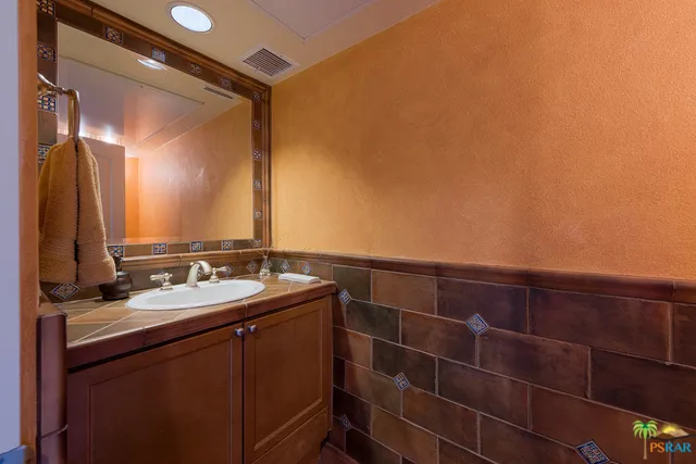 Custom tiled downstairs powder bath.