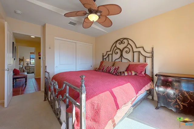 A tiled hallway separates the master bed
