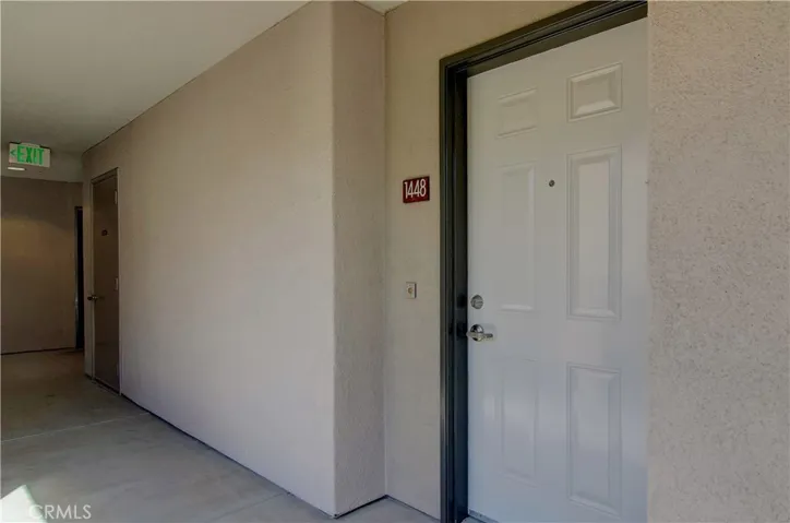 Unit entrance is in sunny and bright section of hallway.