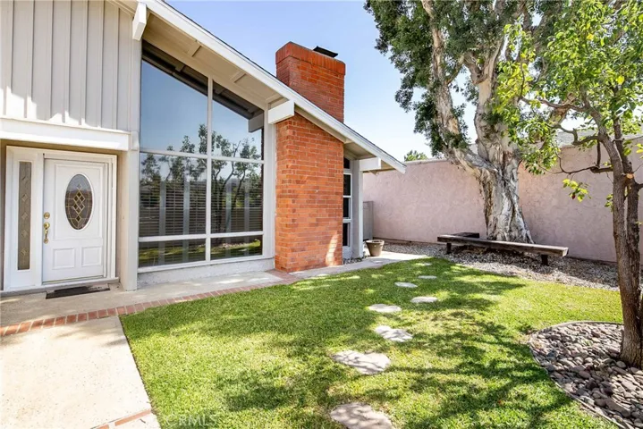 Striking style lines, living room has walls of glass that look out to the front yard.