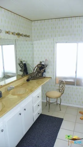Dual Sinks & Cosmetic Seating In Master
