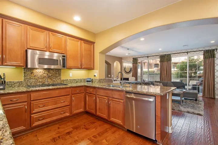 Open and socially connected kitchen with breakfast nook and living room on either side