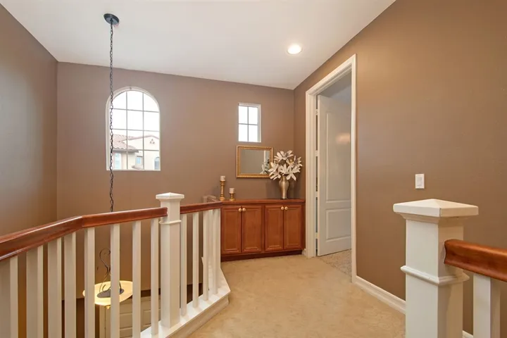 Top of stairs opens into a comfortable foyer with high ceilings