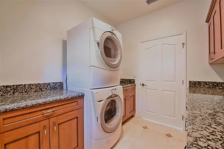 Stackable machines with lots of cabinets, deep sink and granite counter tops.