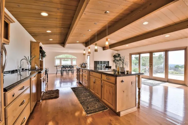 Custom Knotty Alder cabinets with soft close, Sub Zero refrigerator/freezer, warming drawer and 2 builtin cutting boards and spice racks. The Island is over 13 ft. long for great entertaning.