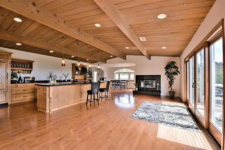 Maple Hardwood flooring, Custom cabinetry throughout the kitchen with knotty Alder and Matching Hutch, warming drawer, Sub Zero refrigerator/freezer and walk in Pantry area..13 ft. Center Island with Granite counter tops and double bullnose edging.