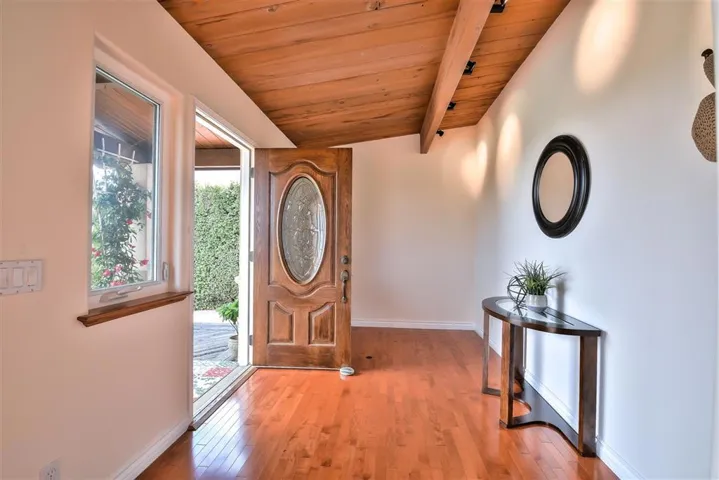Beautiful entrance with Custom door with leaded glass..Wood floors throughout the kitchen and dining room areas.