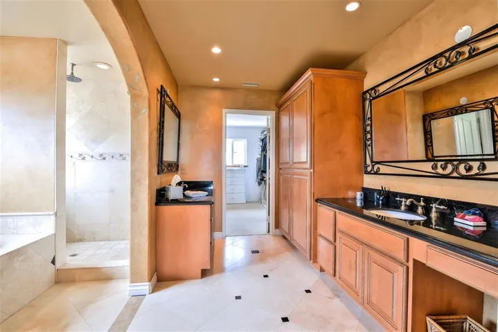 Separate sit down vanity area. Travertine floors and granite counter tops