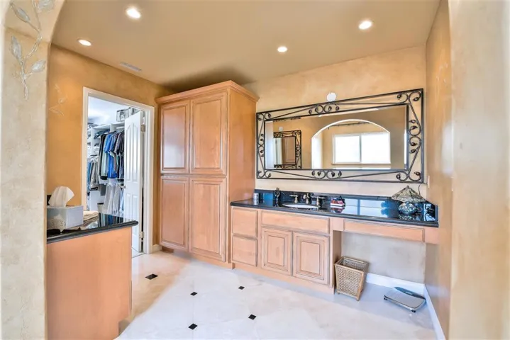 Separate walk in shower and large spa tub and two vanities. Travertine flooring. There is also a Haircare drawer with hidden outlet.