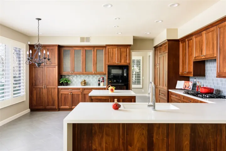 Exquisite remodeled kitchen with rare WALNUT cabinetry, quartz countertops with waterfall edge, under-counter lighting, Sub-Zero built-in fridge/freezer with walnut panel, Dacor range, oven, microwave, custom LED can lighting and more ...