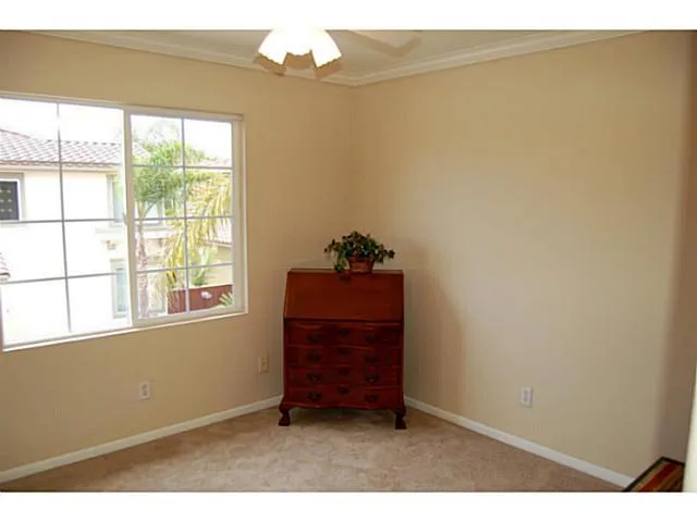 West Bedroom also has a ceiling fan and mirrored wardrobe. Original builder had an option to combine the two secondary bedrooms and make a second master bedroom. See floor plan in attachments.