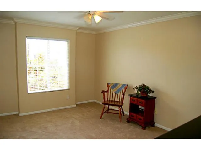 South Bedroom with ceiling fan and mirrored wardrobe. Original builder had an option to combine the two secondary bedrooms and make a second master bedroom. See floor plan in attachments.