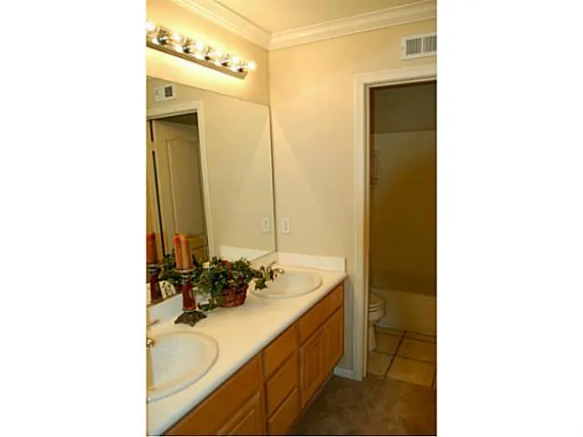 Upstairs second bathroom has dual sinks.