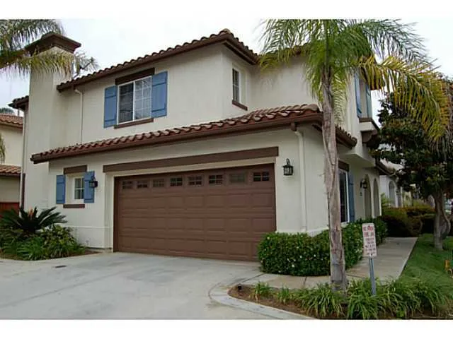 Side view of home has two car garage.