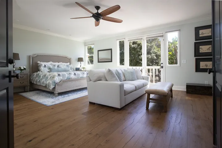 Large master retreat with sitting area and balcony with stunning sunset views