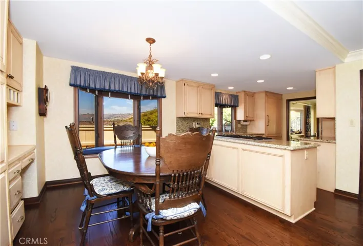 Casual dining area in kitchen, built in desk and storage.