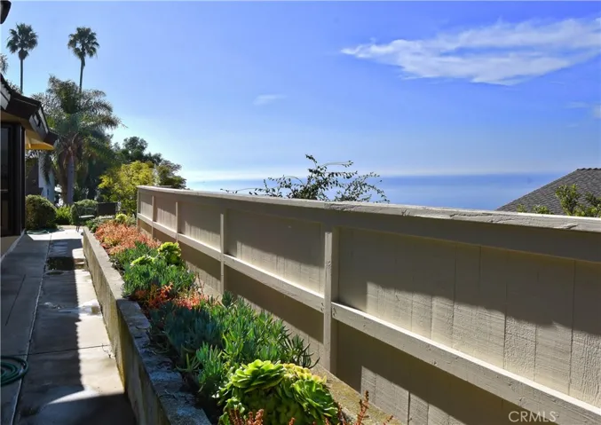 Side yard features built in planters with thriving succulents. Freshly painted exterior stucco.