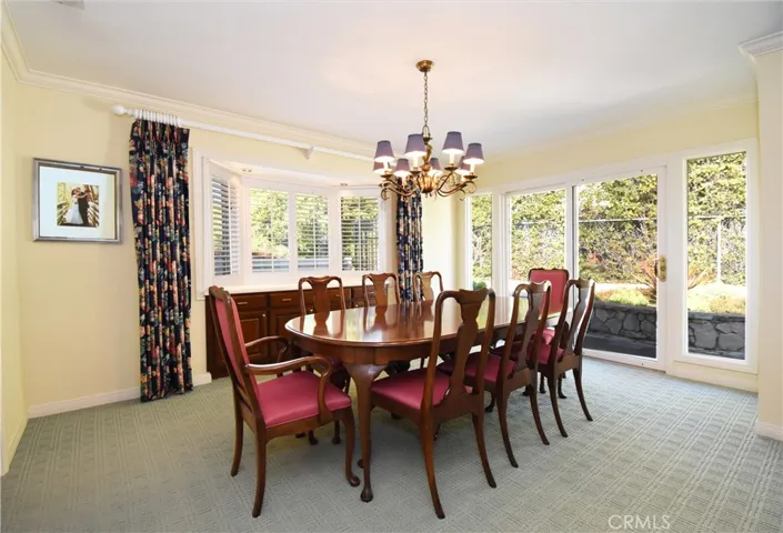 Formal dining room with built in buffet. Access to backyard and pool.