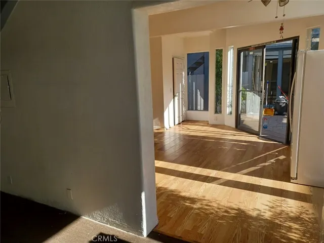 Looking from the larger room on the left side into the smaller room on the right