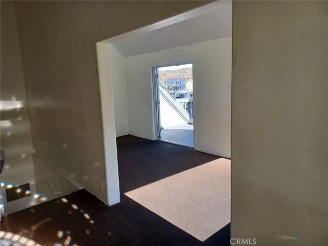 Looking into room 2 upstairs with french doors to outside deck