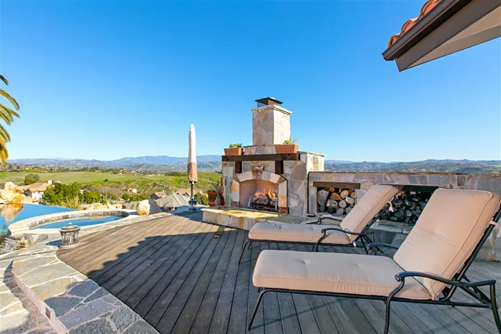 Outdoor custom stone fireplace is on a raised deck off the Master Bedroom.