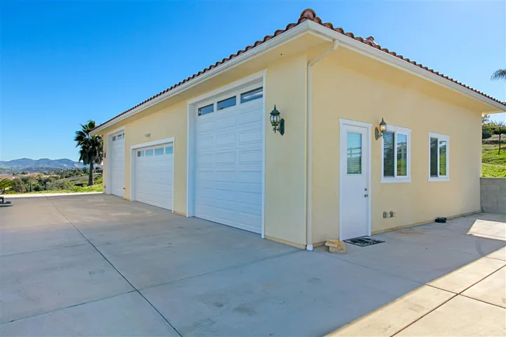 Newly built 56'x30' shop with 2 RV doors 11'6" x 12' wide. Additional vehicle door. Rotary Brand 2 Post car lift conveys, workbench, office, half bath (non-permitted) and storage loft. Microwave and frig convey.