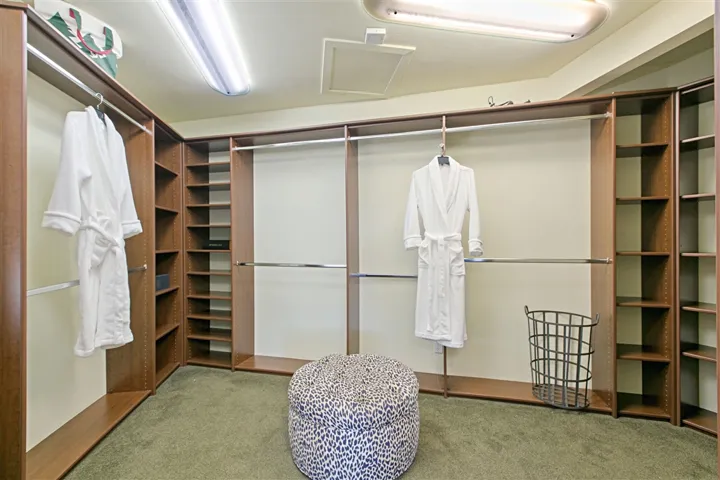 17x13 Master closet with window that lights up the inside of the closet for easy wardrobe coordination.