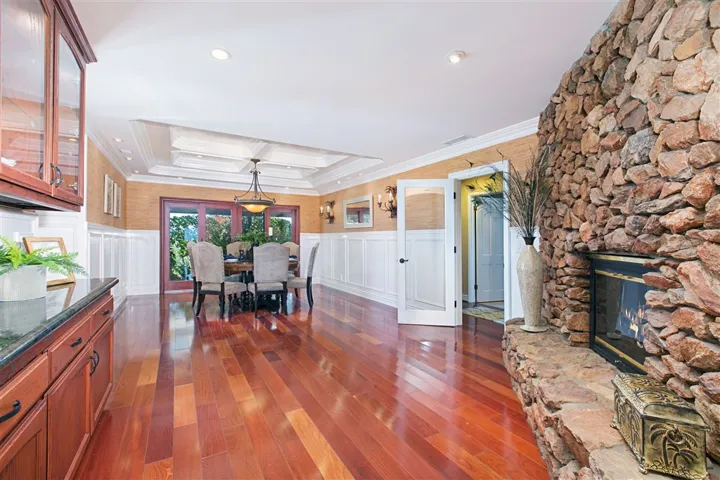 Dining room can accommodate many with room to spread out.  Fireplace keeps your dining atmosphere cozy and comfortable. You won't want to leave this room after you see the detailed coffered ceiling and lighting configuration. Butler pantry is to the left