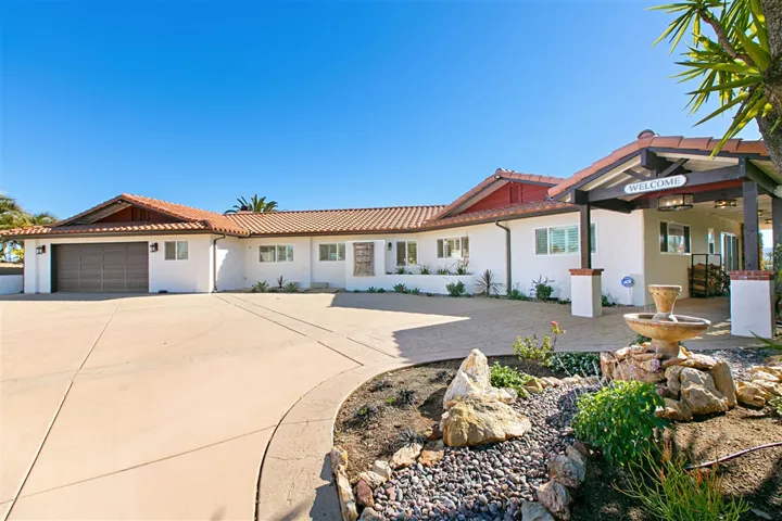 Once you're through the front gates, driveway opens up stamped concrete parking and staging area.