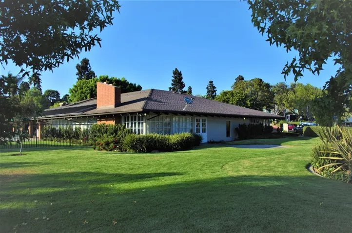 Clubhouse is surrounded by lush lawns and a dog walk area
