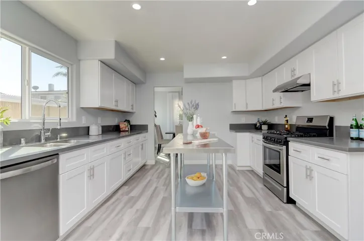 Check out the prep and storage space in this bright white kitchen...