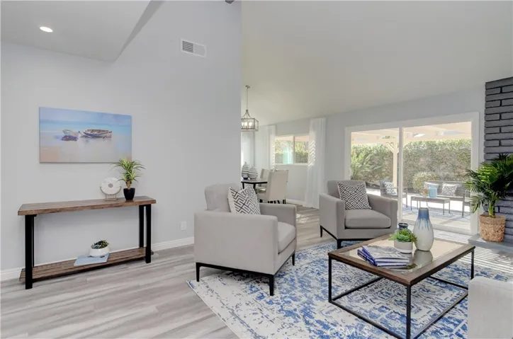 Great room concept has it all...fireplace, volume ceilings and ez flow in and out with huge slider.