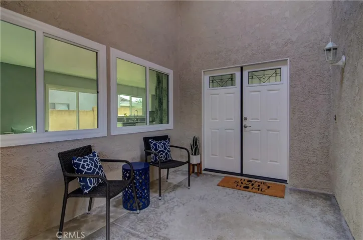 Cozy, covered front porch area has a courtyard/atruim vibe...and is a nice, quiet place to stop...whether coming or going...