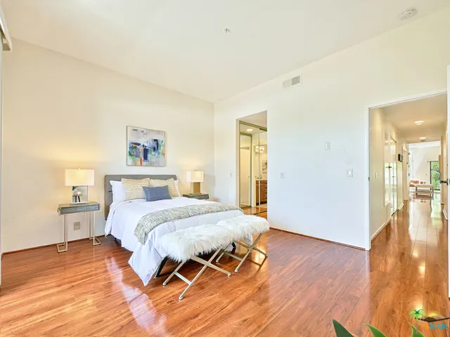 Adjoining master bedroom features two mi
