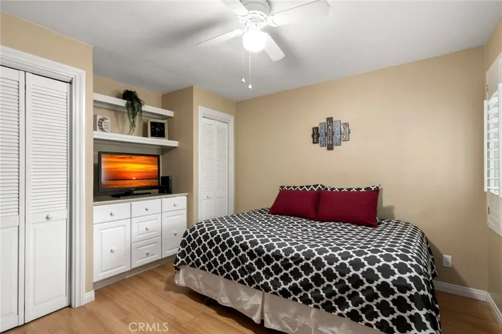 Second bedroom has built-in cabinets and shelves, ceiling fan and two closets.