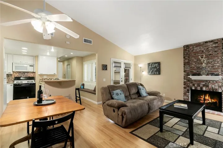 The cozy living room has a gas fireplace and French doors that lead to a large private balcony.