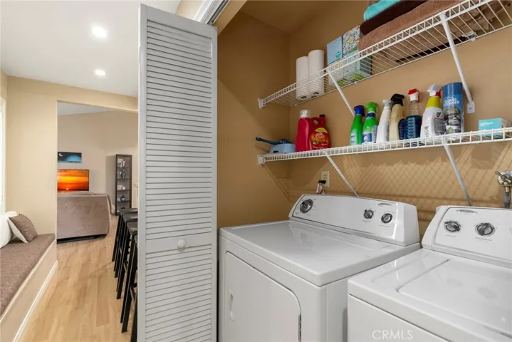 Inside laundry is large enough for full size side by side washer and dryer.  Note window bench across from bar stools.  A nice place to chat with friends while cooking!