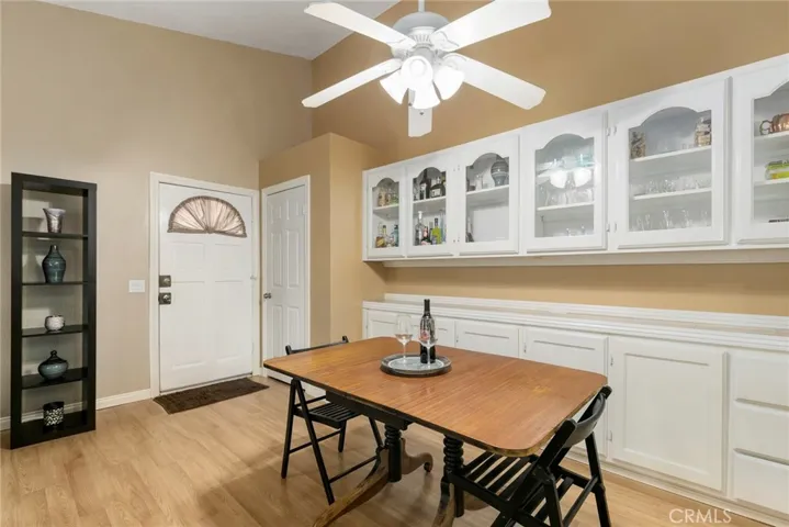 Dining area is adjacent to living room and kitchen with custom built-in cabinets