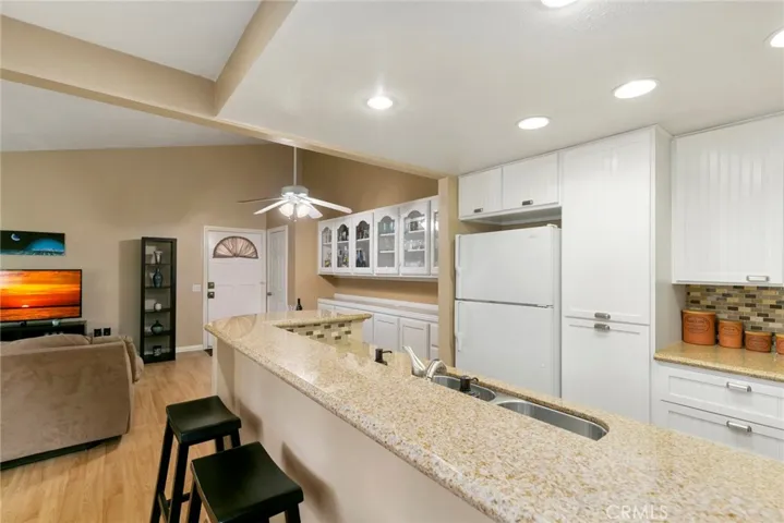 High ceilings, recessed lighting and light laminate wood flooring throughout make this home bright and airy.